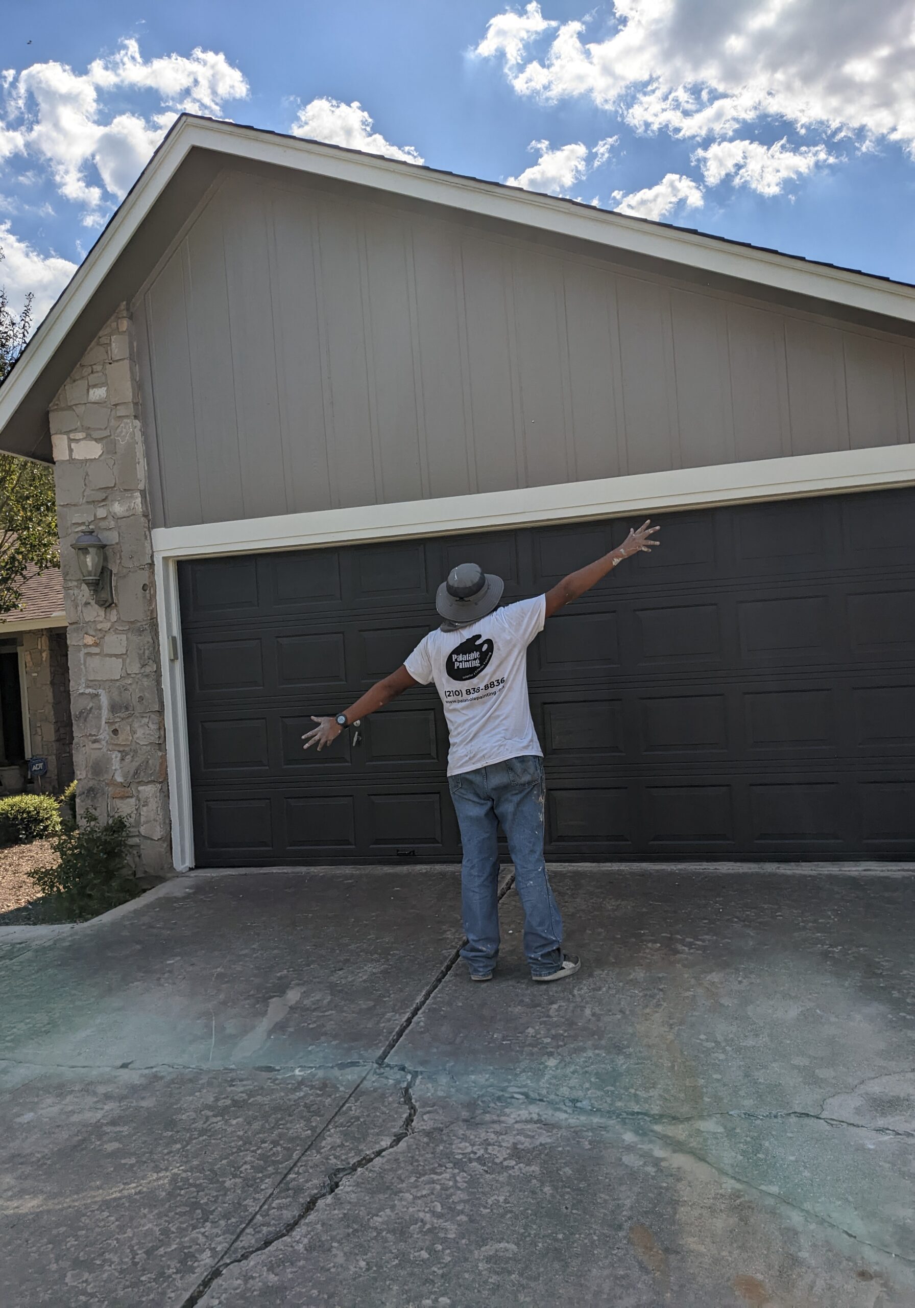 Painter celebrating a finished exterior paint job